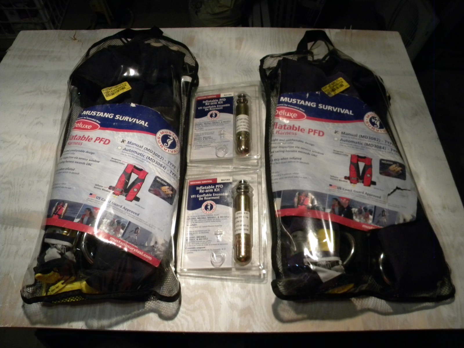 Pair MUSTANG deluxe inflatable PFD’s, with 2 rearm kits & 1 ACR attached strobe